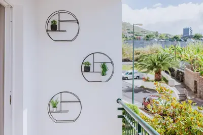 two views of a house with two mirrors on the wall at Funchal Lounge Apartment II by Amazing Madeira in Funchal