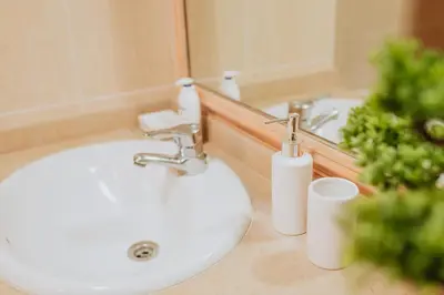 a white sink in a bathroom with a mirror at Funchal Lounge Apartment II by Amazing Madeira in Funchal