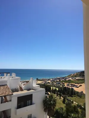 a view of the ocean from a building at Magnolia Mar Apartamentos in Lagos