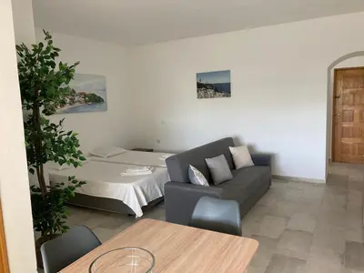 a living room with a couch and a bed at Magnolia Mar Apartamentos in Lagos