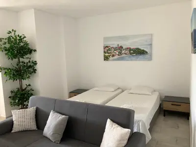 a living room with two beds and a couch at Magnolia Mar Apartamentos in Lagos