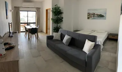 a living room with a couch and a table at Magnolia Mar Apartamentos in Lagos