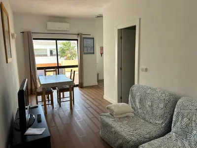 a living room with a couch and a table at Magnolia Mar Apartamentos in Lagos
