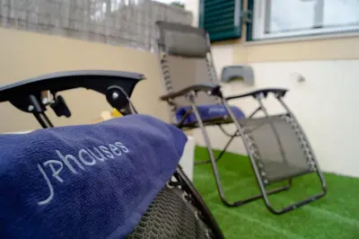 a chair with a pillow on top of it at Porto Santo Blue House in Porto Santo