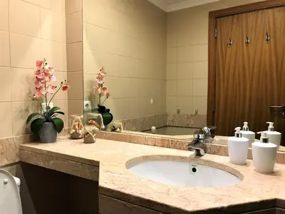 a bathroom with a sink and a large mirror at Funchal Apartment, with pool in Funchal