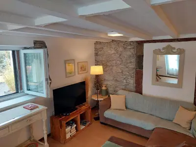 a living room with a couch and a television at Purple Studio in Funchal