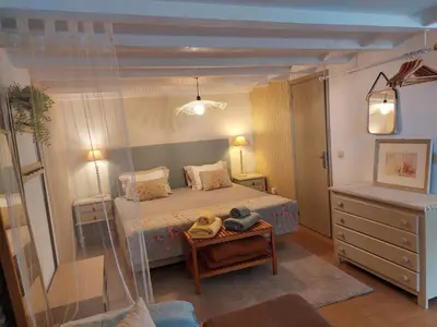 a bedroom with a bed and a dresser and a mirror at Purple Studio in Funchal
