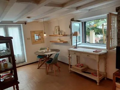 a living room with a table and a window at Purple Studio in Funchal