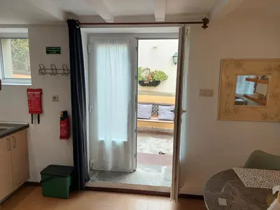 a sliding glass door with a plant on a shelf at Purple Studio in Funchal