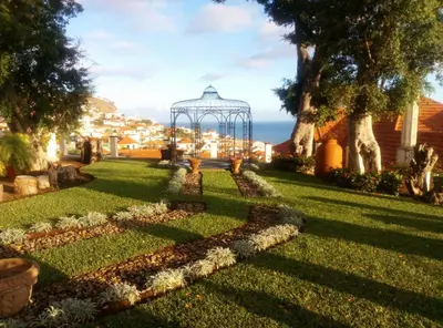 a garden with a gazebo in a yard at Purple Studio in Funchal