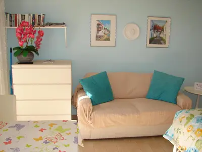a living room with a couch and a dresser at Purple Studio in Funchal