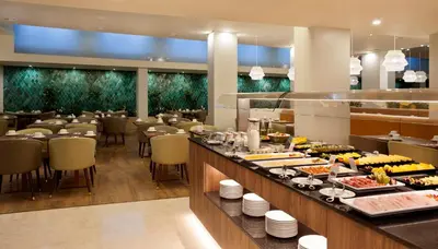 a restaurant with a buffet line of food at TURIM Santa Maria Hotel in Funchal