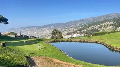 a golfer on a golf course with a pond at Sea and Sun 4 You - Palheiro Village in Funchal