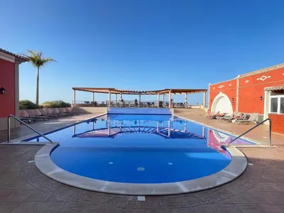 a large swimming pool with blue water at Sea and Sun 4 You - Palheiro Village in Funchal