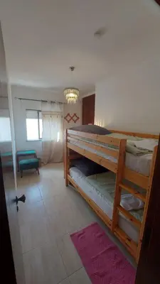 a bedroom with two bunk beds and a chandelier at Casa Rose in Almádena