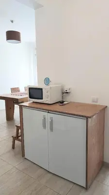 a kitchen with a microwave on top of a counter at Casa Rose in Almádena