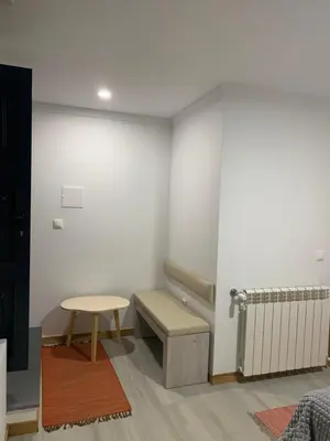 a waiting room with a bench and a radiator at Casa do Ribeiro Frio in Santana