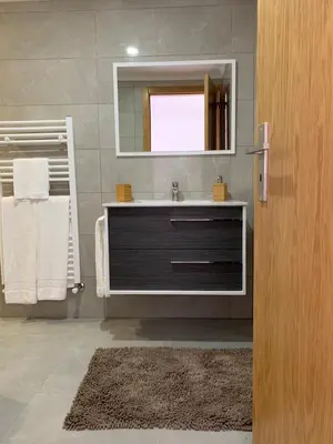 a bathroom with a sink and a mirror at Casa do Ribeiro Frio in Santana