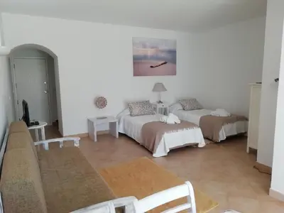a living room with two beds and a couch at Alfazema in Lagos