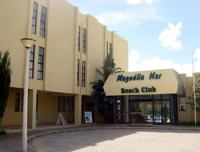a large building with a sign for a beach club at Alfazema in Lagos