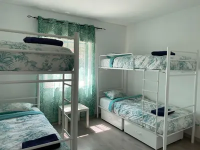 a room with three bunk beds and a window at Sagres Natura in Sagres