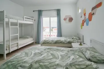 a bedroom with two bunk beds and a window at Sagres Natura in Sagres