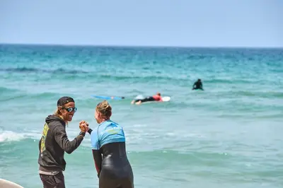 a man and a woman standing on the beach at Sagres Natura in Sagres
