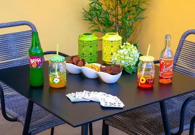 a black table with drinks and a bowl of food at Villa Sunrise View by Homie in Santa Cruz