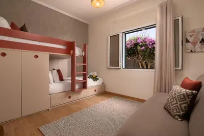 a childs bedroom with a bunk bed and a window at Villa Sunrise View by Homie in Santa Cruz