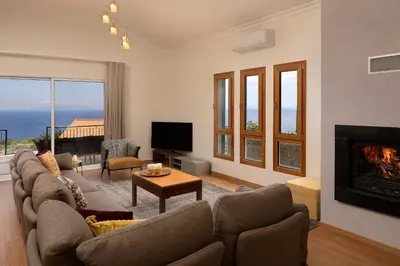 a living room with a couch and a fireplace at Villa Sunrise View by Homie in Santa Cruz