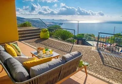 a living room with a couch and a view of the ocean at Villa Sunrise View by Homie in Santa Cruz