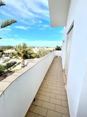 a balcony with a view of the beach at Charming Salema in Salema