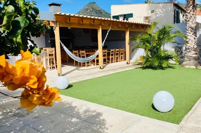 a resort yard with a hammock and a playground at A Casa do Góis - Villa in Porto Santo in Porto Santo