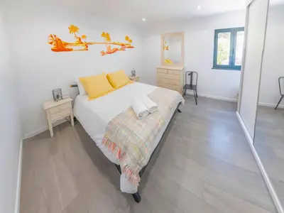 a bedroom with a bed and a nightstand and a bed at A Casa do Góis - Villa in Porto Santo in Porto Santo