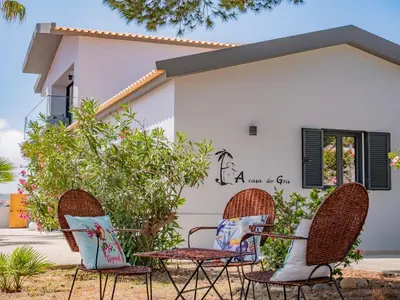 a group of chairs in front of a house at A Casa do Góis - Villa in Porto Santo in Porto Santo