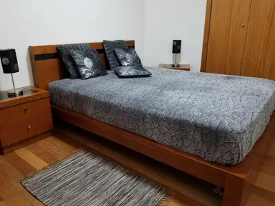 a bed with black pillows on it in a room at VIP Paradise Apartment in Machico