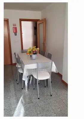 a table with chairs and a vase of flowers on it at VIP Paradise Apartment in Machico