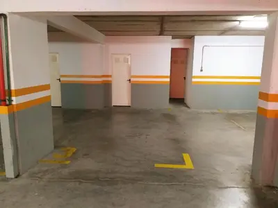 an empty parking garage with orange and white walls at Lido Belissimo in Funchal