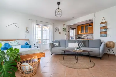 a living room with a couch and a table at Sweet Home Arrifana - Beachhouse by Lisbeyond in Praia da Arrifana