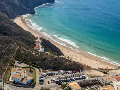 an aerial view of a beach and the ocean at Sweet Home Arrifana - Beachhouse by Lisbeyond in Praia da Arrifana
