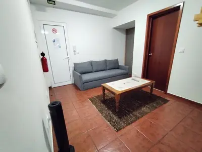 a living room with a couch and a coffee table at Apartamentos Lisboa in Vila do Porto