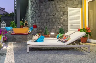 a bed sitting on a patio in front of a building at Zeza´s Garden in Calheta