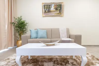 a living room with a couch and a white coffee table at Zeza´s Garden in Calheta