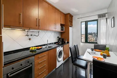 a kitchen with a sink and a dishwasher at Luxury View Apartment Funchal CENTRAL free parking FAMILIES in Funchal
