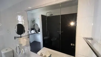 a bathroom with a shower with a glass door at Luxury View Apartment Funchal CENTRAL free parking FAMILIES in Funchal