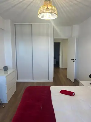 a bedroom with a large white bed with a red blanket at Luxury View Apartment Funchal CENTRAL free parking FAMILIES in Funchal