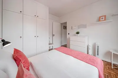 a white bedroom with a white bed and a pink blanket at Luxury View Apartment Funchal CENTRAL free parking FAMILIES in Funchal