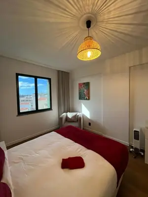 a bedroom with a large bed and a chandelier at Luxury View Apartment Funchal CENTRAL free parking FAMILIES in Funchal