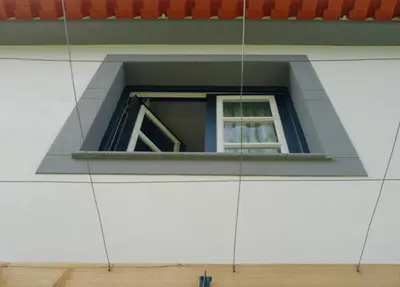 a window on the side of a building at Casa Oliveira Esmeraldo - Guest Houses in São Vicente