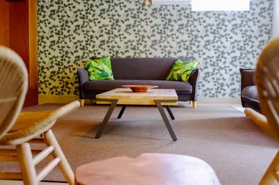 a living room with a couch and a coffee table at Casa Oliveira Esmeraldo - Guest Houses in São Vicente